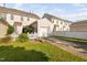Charming townhome exterior with attached garage and well-maintained lawn and picket fence at 210 Presidents Walk Ln, Cary, NC 27519