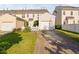 A townhouse exterior features an attached garage and a driveway leading to the street at 210 Presidents Walk Ln, Cary, NC 27519
