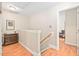 Second story hallway features warm paint, traditional molding, and natural light at 210 Presidents Walk Ln, Cary, NC 27519