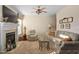 Bright living room with a fireplace, recliner, sofa, and a ceiling fan at 210 Presidents Walk Ln, Cary, NC 27519