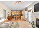 Inviting living room and kitchen features an open layout, hardwood floors, and stainless steel appliances at 210 Presidents Walk Ln, Cary, NC 27519