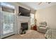 Comfortable living room with a fireplace, TV, and access to an outdoor patio at 210 Presidents Walk Ln, Cary, NC 27519