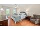 Spacious bedroom with great natural light, hardwood floors, and calming wall colors at 210 Presidents Walk Ln, Cary, NC 27519