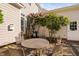 A private patio with flowering trees, a table and chairs, and comfortable seating at 210 Presidents Walk Ln, Cary, NC 27519