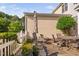 Landscaped patio area with potted plants, comfortable seating, and an umbrella for shade at 210 Presidents Walk Ln, Cary, NC 27519