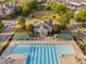 Aerial view of a community clubhouse and pool with surrounding lounge areas and lush trees at 210 Presidents Walk Ln, Cary, NC 27519