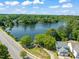 Scenic aerial view of a tranquil lake surrounded by lush greenery and beautiful homes in a well-planned community at 2105 Metacomet Way, Raleigh, NC 27604