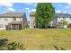 Wide backyard offering plenty of green space, back patios, and shade trees at 2105 Metacomet Way, Raleigh, NC 27604