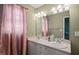 Bathroom featuring dual sinks, updated vanity, a large mirror and ample lighting at 2105 Metacomet Way, Raleigh, NC 27604