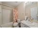 Bright bathroom featuring a single vanity, a shower-tub combo, and a colorful shower curtain at 2105 Metacomet Way, Raleigh, NC 27604