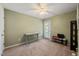 Bright bedroom with neutral walls, standard closet, and desk with a door to the outside at 2105 Metacomet Way, Raleigh, NC 27604