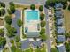 Aerial view of a large community pool, surrounded by lounge chairs, trees, and a parking lot at 2105 Metacomet Way, Raleigh, NC 27604