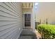 A close-up of the front door, featuring a classic design and decorative lighting at 2105 Metacomet Way, Raleigh, NC 27604