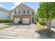 A charming two-story home with a brick facade and attached two-car garage at 2105 Metacomet Way, Raleigh, NC 27604