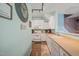 Open kitchen with white cabinetry, a breakfast bar, and hardwood floors leading to the dining area at 2105 Metacomet Way, Raleigh, NC 27604