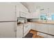 A spacious kitchen with white cabinets, modern appliances, and wood flooring at 2105 Metacomet Way, Raleigh, NC 27604