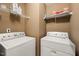 Practical laundry area with washer, dryer, and storage shelves at 2105 Metacomet Way, Raleigh, NC 27604