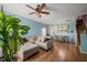 Open-concept living room with hardwood floors, ceiling fan, and adjacent dining area at 2105 Metacomet Way, Raleigh, NC 27604