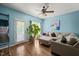 Cozy living room featuring a large sectional, hardwood floors, ceiling fan, and neutral tones at 2105 Metacomet Way, Raleigh, NC 27604