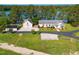 Lakeside home boasts manicured lawn, detached garage, and waterfront access at 215 Collins Rd, Lillington, NC 27546