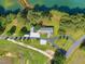 Aerial view of waterfront home with landscaping and private access to the lake at 215 Collins Rd, Lillington, NC 27546