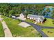 Stunning lakefront property with manicured landscaping, detached garage, and serene surroundings at 215 Collins Rd, Lillington, NC 27546