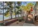 Back deck with stairway and lake view, perfect for enjoying the outdoors at 215 Collins Rd, Lillington, NC 27546