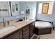 Well-appointed bathroom with a soaking tub, double vanity, and stylish fixtures at 215 Collins Rd, Lillington, NC 27546