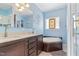 Bathroom with a soaking tub, vanity, tile flooring, and a glass enclosed shower at 215 Collins Rd, Lillington, NC 27546