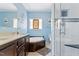 Bathroom featuring a soaking tub, vanity, tile flooring, and a glass enclosed shower at 215 Collins Rd, Lillington, NC 27546