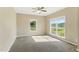 Bright bedroom featuring neutral walls, carpet flooring, and natural light from the multiple windows at 215 Collins Rd, Lillington, NC 27546