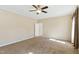 Spacious carpeted bedroom featuring a ceiling fan and a door leading to another room at 215 Collins Rd, Lillington, NC 27546