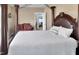 Spacious main bedroom with a four poster bed and a peak into the sitting area at 215 Collins Rd, Lillington, NC 27546