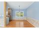 Bright dining area with a large window offering serene lake views, complemented by modern lighting at 215 Collins Rd, Lillington, NC 27546