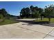 Long driveway leading to the home, with lush landscaping on both sides at 215 Collins Rd, Lillington, NC 27546