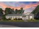 Home featuring a cozy front porch and tasteful landscaping, set against a beautiful sunset sky at 215 Collins Rd, Lillington, NC 27546