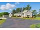 Charming home with well-maintained landscaping, an asphalt driveway, and a detached garage with mature trees at 215 Collins Rd, Lillington, NC 27546