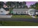 Charming home featuring an attached garage and a well-manicured front yard with a lake view, perfect for peaceful living at 215 Collins Rd, Lillington, NC 27546