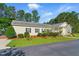 Well-manicured front yard with lush green grass, mulch beds, and manicured shrubs surrounds the home at 215 Collins Rd, Lillington, NC 27546