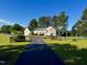 Inviting home exterior with a well-manicured lawn and private drive at 215 Collins Rd, Lillington, NC 27546