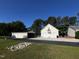 Spacious three-car garage with an additional outdoor storage shed at 215 Collins Rd, Lillington, NC 27546