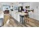 Bright kitchen with island, bar seating, stainless steel appliances, and modern light fixtures at 215 Collins Rd, Lillington, NC 27546