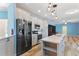 Updated kitchen features stainless steel appliances, a center island with pendant lighting, and ample counter space at 215 Collins Rd, Lillington, NC 27546