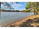 Beautiful lake view on a sunny day with trees framing the scene at 215 Collins Rd, Lillington, NC 27546