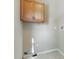 The laundry room features tile floors and wooden cabinets, providing ample storage space at 215 Collins Rd, Lillington, NC 27546