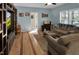 Comfortable living room featuring hardwood floors, a ceiling fan, a sofa, and built-in shelving and cabinets at 215 Collins Rd, Lillington, NC 27546