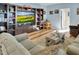 Cozy living room with built-in shelving and cabinets, hardwood floors, comfortable sofa, and area rug at 215 Collins Rd, Lillington, NC 27546