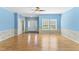 Inviting living room with hardwood floors, neutral paint, large window for natural light, and a ceiling fan at 215 Collins Rd, Lillington, NC 27546