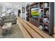 Open concept living room with hardwood floors, built-in shelving and cabinets, and a view of the kitchen at 215 Collins Rd, Lillington, NC 27546