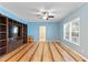 Spacious living room featuring custom built-ins, hardwood floors, and a modern ceiling fan at 215 Collins Rd, Lillington, NC 27546